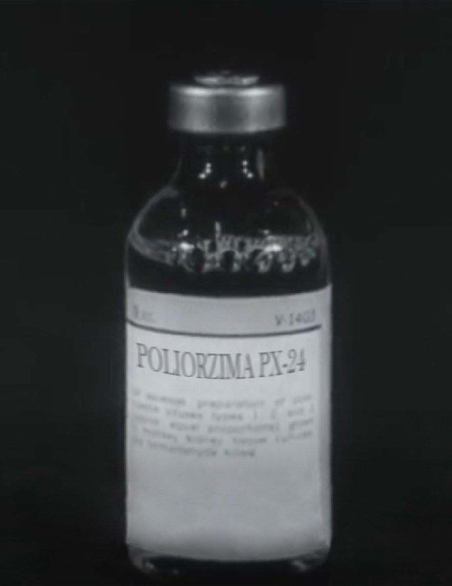 Black and white photograph of a glass vial filled with liquid. A white label reads Poliorzima PX-24 followed by a blurry text. 